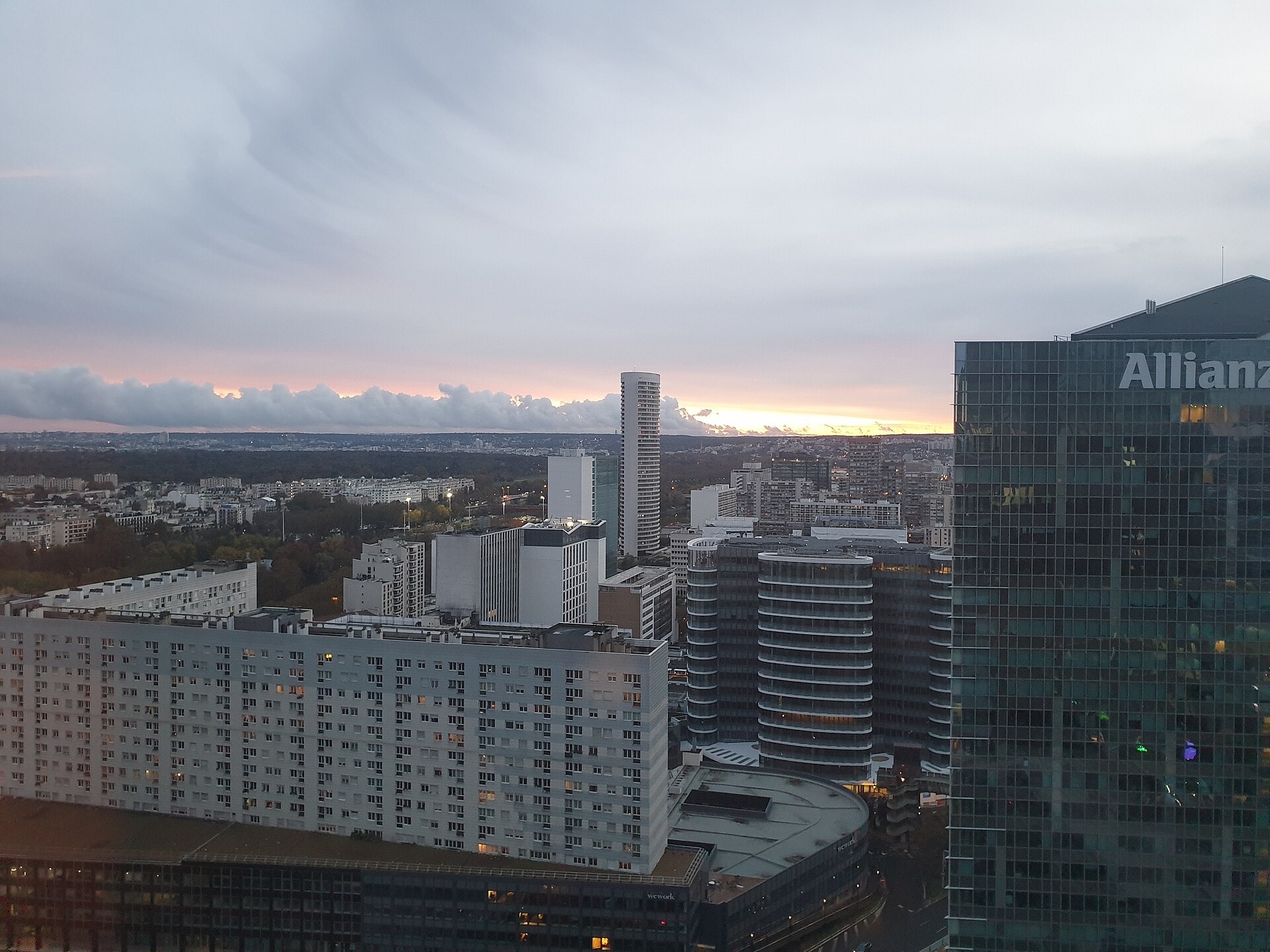 La Défense in Paris at dusk on 30 October 2021, seen from a hotel lounge, with offices and apartment blocks.