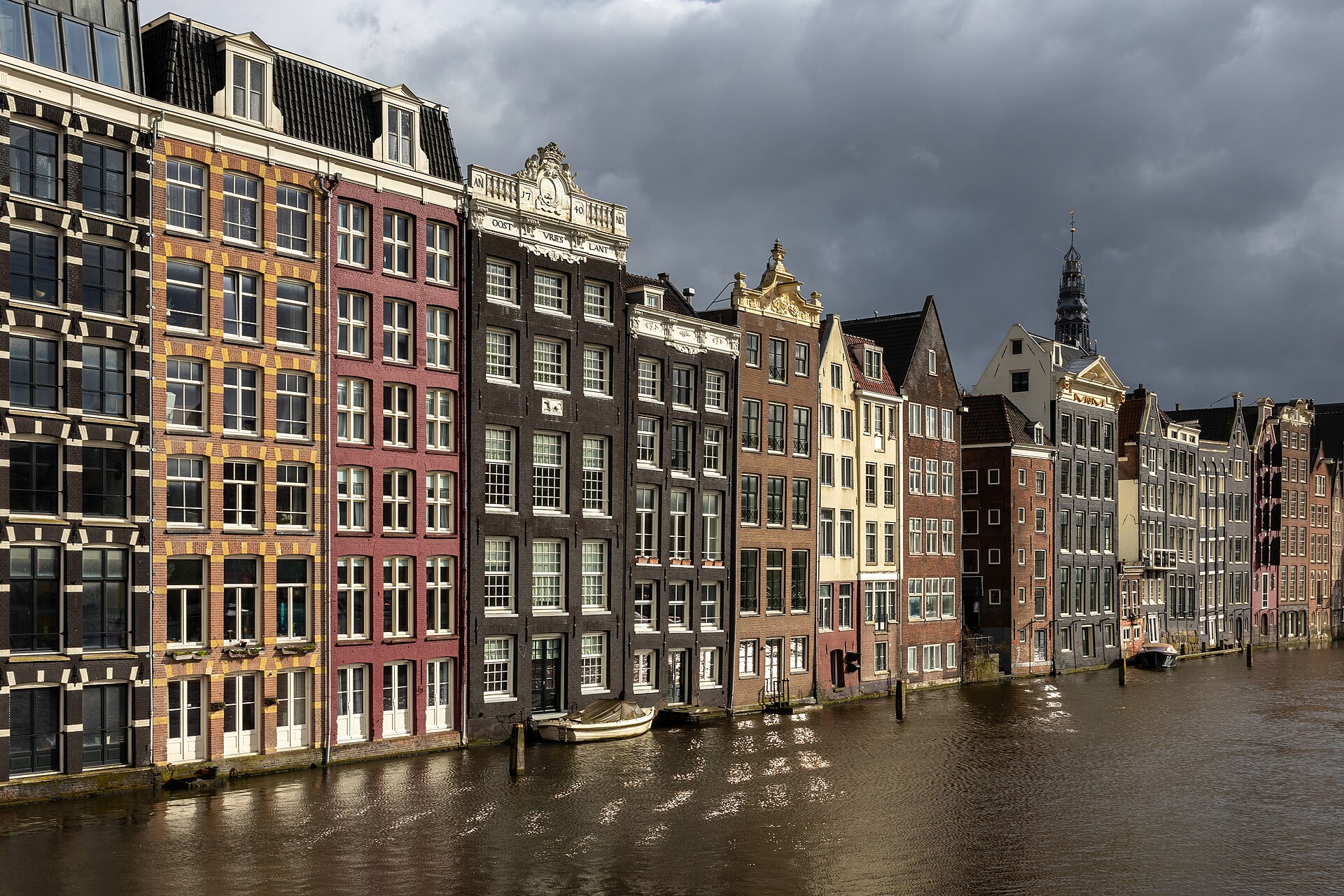 Canal houses along Damrak in Amsterdam at golden hour, 24 April 2024.