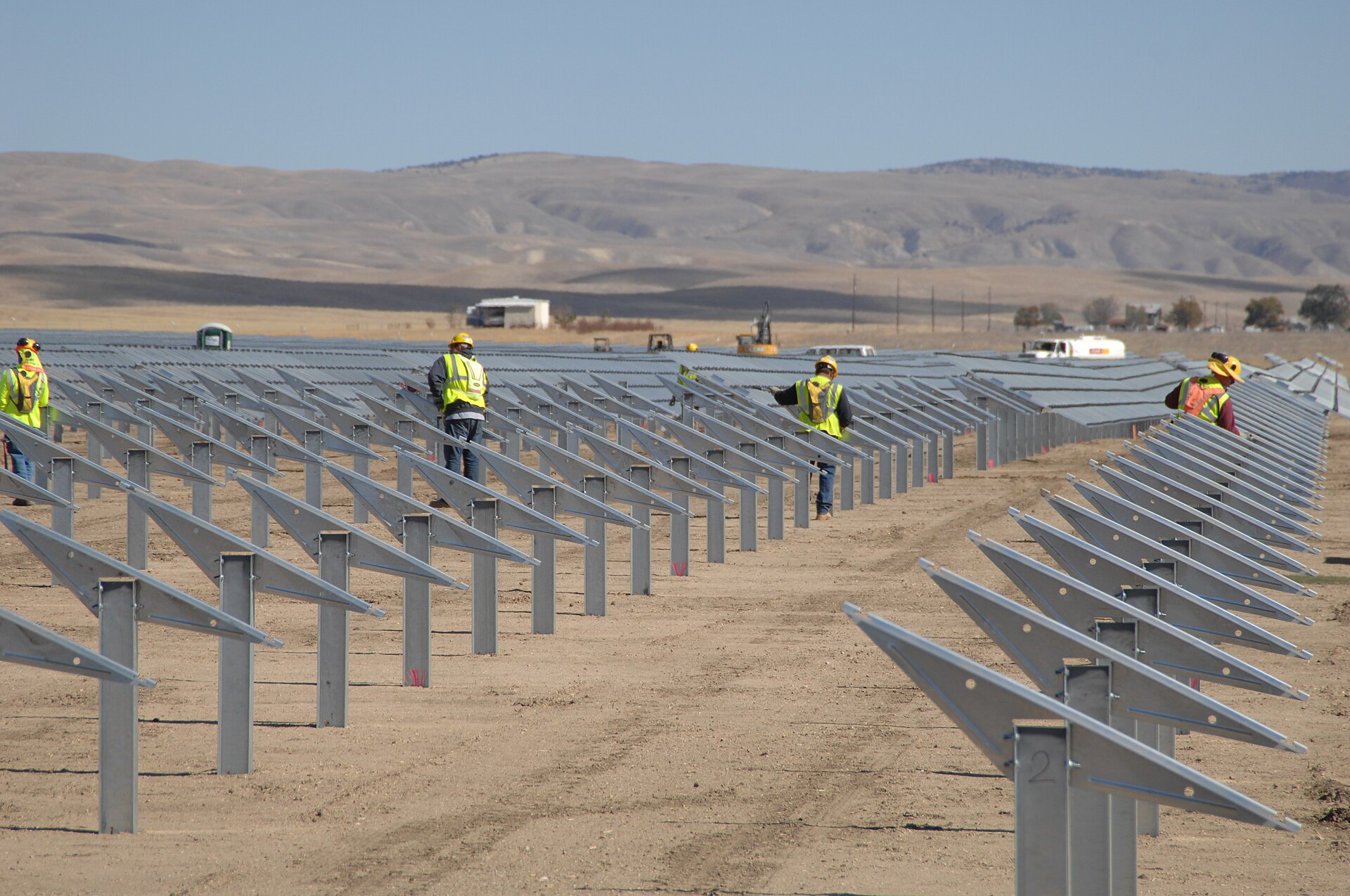 Workers among rows of panels at Topaz Solar Farm, California, 24 October 2012.